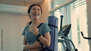 Woman wearing fitness clothes carrying a yoga mat in the gym ,Smiling happily while exercising, Exercise for health and shape, Morning activities for health lovers.