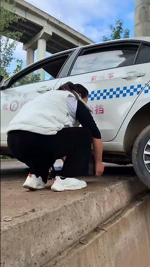A Female Driver Accidentally Pushed Her Car Wheel Off A Curb While Reversing.