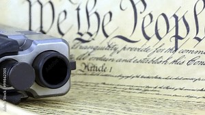US Constitution Bill of Rights with hand gun - History of the Second Amendment