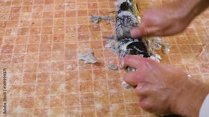 Cleaning and scaling a large fresh carp fish