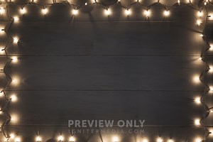 Border Of Christmas Lights On A Wood Background. - Stock Photos