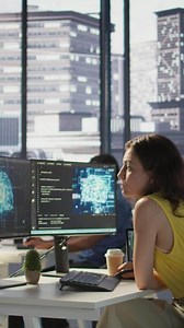 Vertical Employee using AI technology to design algorithms that enable machines to learn from data. Admin in office training large scale deep learning models with artificial intelligence tech, camera B