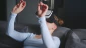 Woman in virtual reality goggles enters metaverse, controls immersive...