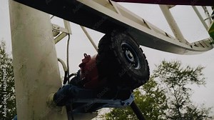 A close-up of an electric motor that rotates a Ferris wheel. Shooting up close in motion