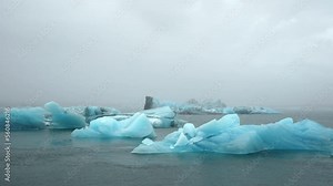 Blue Iceberg in Foggy Glacier Lagoon, Pure Nature in Iceland. Beautiful Natural Miracle in North Country. Ancient Blue Ice Is Melting Due To Global Warming. Winter and Ice Concept. Shot in 8k