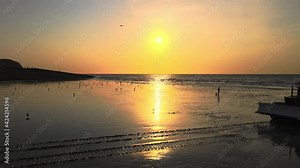 Hastings Port, East Sussex | UK - 2020.09.19: Aerial view of the bulldozer pulls a fishing boat out of the sea Sunrise with Hastings fishing boats on the beach at Rock-a-Nore