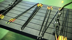 Arrows and Bows Displayed on Rack in Archery Range