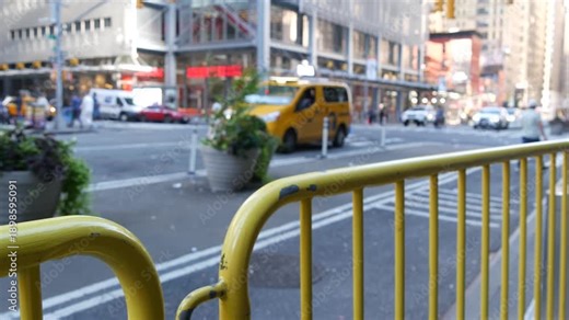 Manhattan Midtown street New York City, United States of America. Port authority bus terminal. Defocused car traffic on urban road, 8th avenue in Hells Kitchen. People pedestrian, yellow taxi cab.
