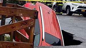 Sinkhole opens up, swallows parked car in Maspeth, Queens