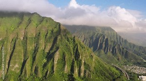Beautiful Hawaii nature. Aerial view cars driving by road to tunnel in steep green mountain. Interstate H3 the most expensive highway in USA. Main road of Oahu island with breathtaking landscape 4K