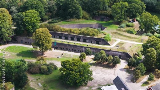 brick barracks embedded grassy embankments stepped earthworks tree lined paths open courtyards layered historic fortifications wooded landscape roman fort long castellum fectio utrecht