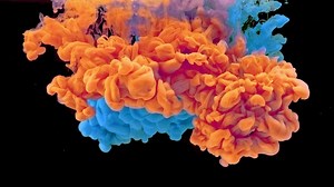 Bright orange and blue ink exploding - Free Stock Video