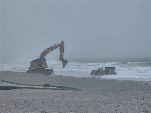 Bulldozer stuck in the water at Indian River Inlet north side beach