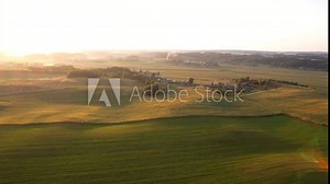 Rural landscape. Country houses in countryside. Village Home at farm field. Roofs of Wooden house in Russian village. Agricultural field with Suburban house. Cuntryside on sunset, aerial view.