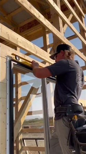 the process of installing glass windows in a house building wooden