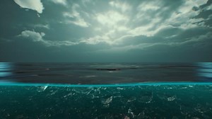 Split view over and under water in the Caribbean sea with clouds