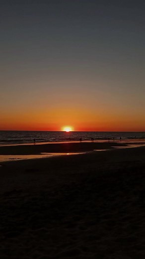 Stunning Beach Sunset Over Calm Ocean