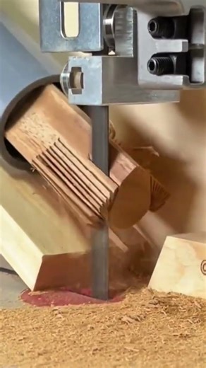 cutting the edge of thin wooden strips with a sharp metal band saw machine very neatly and precisely
