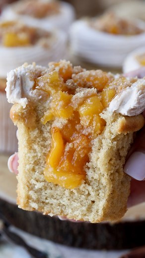 This is a wonderful recipe for Peach Cupcakes, made from a fluffy spiced cupcake, filled with Peach Jam Filling, topped with Spiced Buttercream, and Streusel Crumbs. 🍑 Check out this amazing recipe here: https://www.piesandtacos.com/peach-cupcakes/ | Pies and Tacos