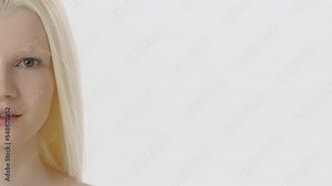 Beauty Woman face Half Portrait. Beautiful Spa model Girl with Perfect Fresh Clean Skin. Albino Female with Blonde hair looking at camera and smiling. Youth and Skin Care Concept. Isolated on a white Stock Video