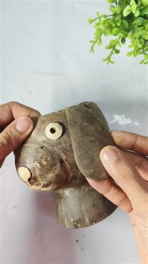 Beautiful Coconut Shell Dog Model Plant Pot | Cute DIY Craft --- 📄 Description Transform a simple coconut shell into a cute dog-shaped plant pot! 🐕🌿 This handcrafted model is perfect for home décor, garden spaces, or gifting. Made fully from natural coconut shell, it brings a rustic charm and eco-friendly touch to your space. In this craft, the coconut shell is shaped and polished to create a dog’s head and body, with a built-in mini pot for succulents or small plants. A perfect mix of creati