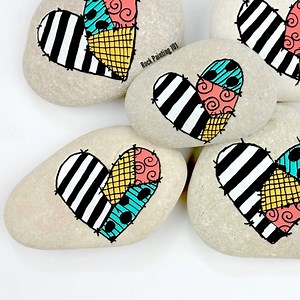 You can do these patchwork hearts to any theme, but ours today are Jack & Sally from The Nightmare Before Christmas 🖤 **SUPPLIES** If you need rock painting supplies please consider using our links below. We will make a small commission at no extra cost to you. I used DecoArt white acrylic paint for the hearts. The colors were from the pastel set of fine tip (3M) Poscas. Then the extra fine tip black (1M) for the lining and details. Shop supplies on Amazon: https://amzn.to/3Xm2pZi 🧡🖤FULL HALL