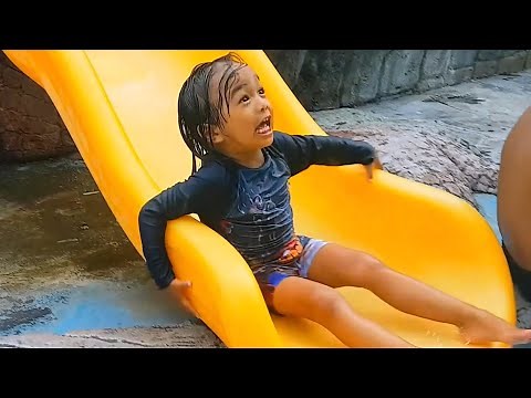 Funny Kids at Children's Waterpark Swimming Pool and Slides