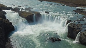 Godafoss Waterfall in Summer Sunny Day. Iceland. Aerial View. Drone Flies Downwards, Tilt Up