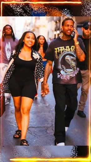 Rapper Lil Durk walks hand in hand with girlfriend India Royale down a city street
