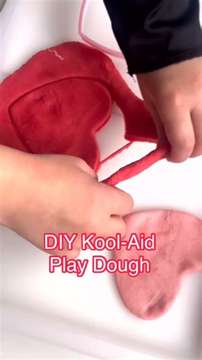 Play dough with a Kool twist! We love this no-cook, 5 ingredient play dough recipe that feels, looks, and smells amazing for the ultimate sensory play! 3/4 cup flour 1/4 cup salt 1 kool-aid packet (we used grape, strawberry, and cherry for Valentine’s Day fun!) 2 tablespoons canola oil 1 cup of boiling water Just mix all ingredients until it starts to form dough. Then knead with your hands, adding extra flour if it’s sticky. That’s it! | Simply Playful Learning