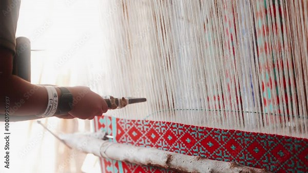 Hand loom, ancient carpets production technique. Working on a handloom, a man using a handloom to create for traditional Persian carpet in Iran village. High quality Super Slow Motion 4K video