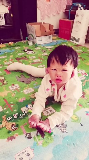 Toddler Enjoys Playtime with Colorful Comb