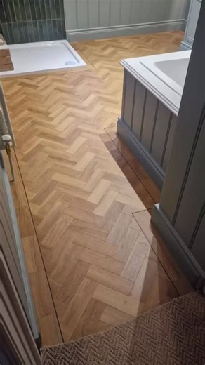Honey oak in a small parquet is already giving warmth and texture, but adding a border and trim takes it straight into “boutique hotel” territory. Amtico Spacia is such a smart choice for a bathroom too—practical and pretty, which is the dream combo. Another fantastic job fitted by Paul Hawthorne 👏 Certainly makes mornings easier. It’s the kind of space where you don’t mind lingering a bit, even before coffee ☕✨ | Glasgows of Lisburn Flooring Specialists