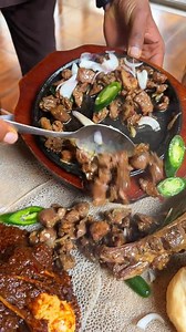 Sizzling Tibs fresh off the biret mitad—juicy, tender, and bursting with smoky flavor. The crispy edges and the rich spices make every bite pure bliss. This is Tibs at its finest, straight from the heart of Ethiopian tradition. Hungry yet?🔥 .. (📸: @gebeta_cology Via TikTok) Join the Moya Fam for Ethiopian food content @balemoya .. #ethiopianfood #ethiopia #eastafricanfood #africanfood #balemoya | Balè Moya