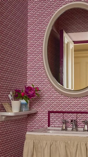 The making of a small Mrs Platt tile backsplash. Perfectly matched to the wallpaper repeat, creates a harmonious flow between wall and surface. The look is completed with our studded trim and aubergine grout lines that blend rather than contrast. #bathroomdesign #interiorinspiration #pinkinteriors #patterndrench #powderroom