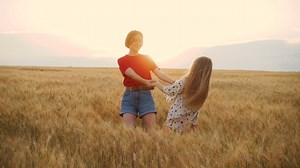 Two young girls spinning in a wheatfield - Free Stock Video