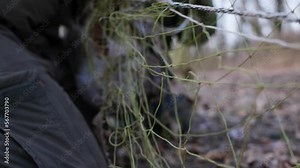 Wild hare caught in a trap net. Hare trapping for relocation. Resettlement of hunting resources. Unleashing the animal from the trap nets. 4K slow motion 120 fps video