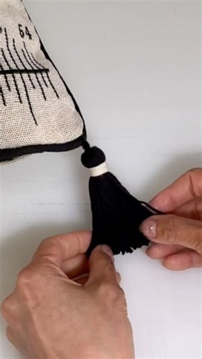 Notches Sewing on Instagram: "Easily make and attach 2-colour tassels to any project with this quick and simple method. Perfect for cushions, blankets, table runners, bookmarks, towel holders, pouches, bags, clothing, and more! All you need is a needle with a large eye, such as a tapestry or chenille needle and any type of yarn or cording to create tassels of any length and fullness.( I’m using cotton yarn here!) 🎥 Find more sewing tutorials on my Youtube channel : Notches Sewing Add a pop of c