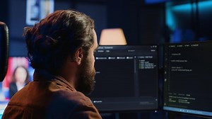 Developer overthinking solutions while doing programming during remote job shift in home office. IT admin working on computer in apartment late at night, thinking how to fix bugs, camera A close up