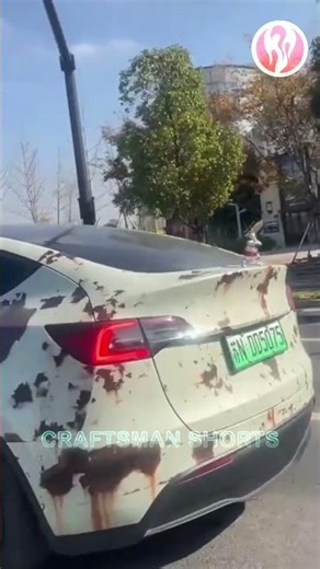 Tesla | This Tesla has a lot of rust on its body.