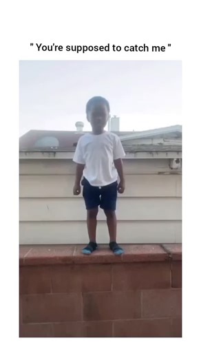Wow Reels Hub on Instagram: "This viral reel features a young boy standing on the edge of a brick wall while a man behind the camera encourages him to jump down. After a moment of hesitation, the boy leaps forward with his arms outstretched, but instead of being caught, he lands directly on the concrete pavement below. The child sits up looking shocked and pained, clutching his leg as he reproachfully tells the man that he was supposed to catch him. The man filming continues to laugh as the boy 