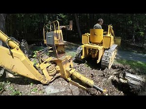 Moving a John Deere backhoe and breaking it