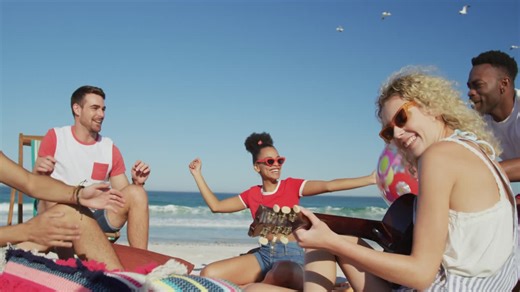 Young adult friends hanging out together at the beach 4k | Premium Stock Video Footage