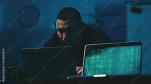 Male hacker typing hacking code on laptop, stealing information, ddos attack
