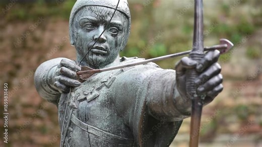 The Robin Hood statue stands proudly on Castle Road in Nottingham, England, aiming his arrow toward the historic gatehouse of Nottingham Castle.