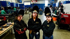 Female students learn welding skills