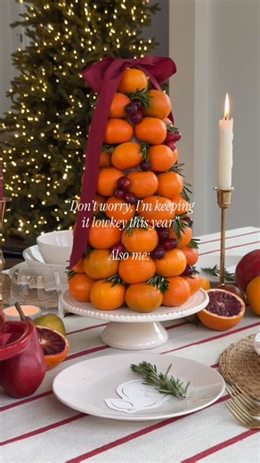 Tableshoppe Co. | Staci on Instagram: "Proceeds to make an orange topiary 🤪 How to make this centerpiece— 1. Wrap a 12” styrofoam cone with Saran Wrap to make it food safe. 2. Poke the dull end of a toothpick into the side of the orange. Attach the orange to the cone using the toothpicks sharp end. Repeat this step all around the base of the cone. 3. Start the next layer by stacking the orange above where two oranges meet, so the next layer is offset. Repeat this step until you get to the top. 
