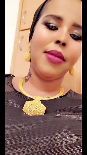 Stunning Black Outfit with Gold Accessories in Elegant Setting