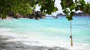 Ocean waves on tropical beachwith rocks - Free Stock Video