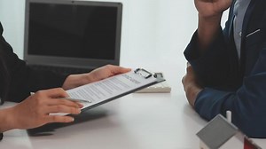 Download Sale representative offer house purchase contract to buy a house or apartment or discussing about loans and interest rates for free